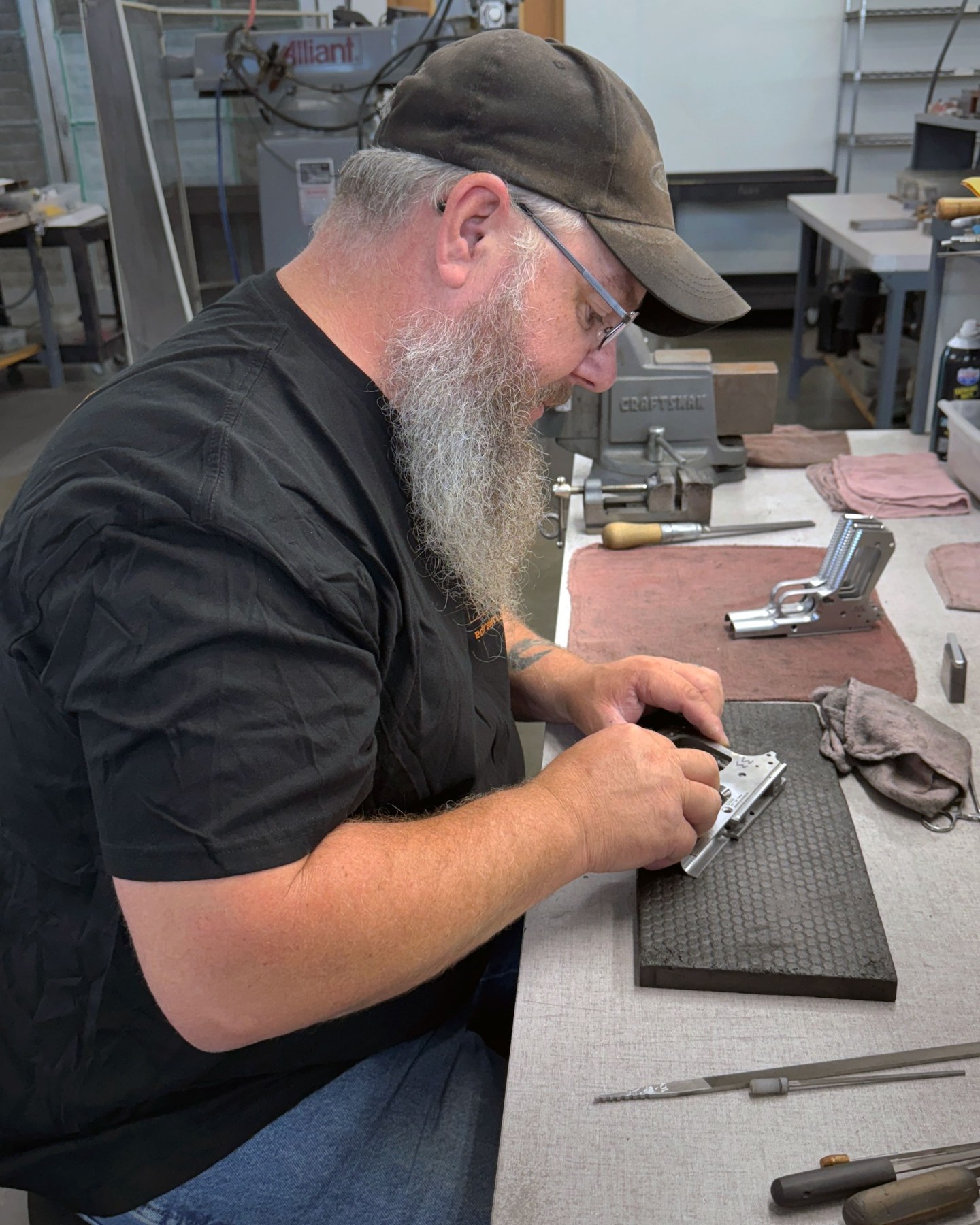 Ed Brown craftsman hand fitting a 1911 at the bench